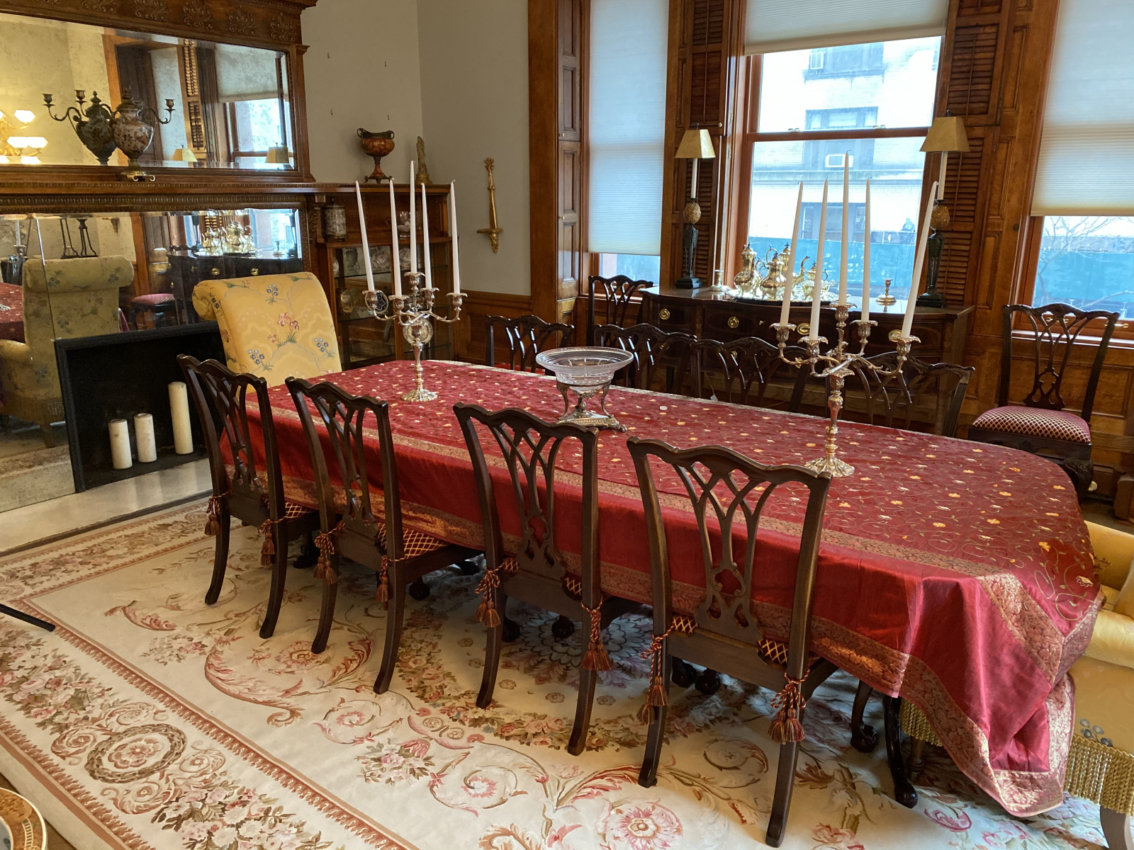 Expansive entertaining space like this beautiful dining room with Drexel Heritage mahogany dining table and set of 10 fine quality carved mahogany dining chairs, a pair of Drexel Heritage large scale upholstered armchairs, and beautiful room size Aubusson carpet with swan motifs by Stark